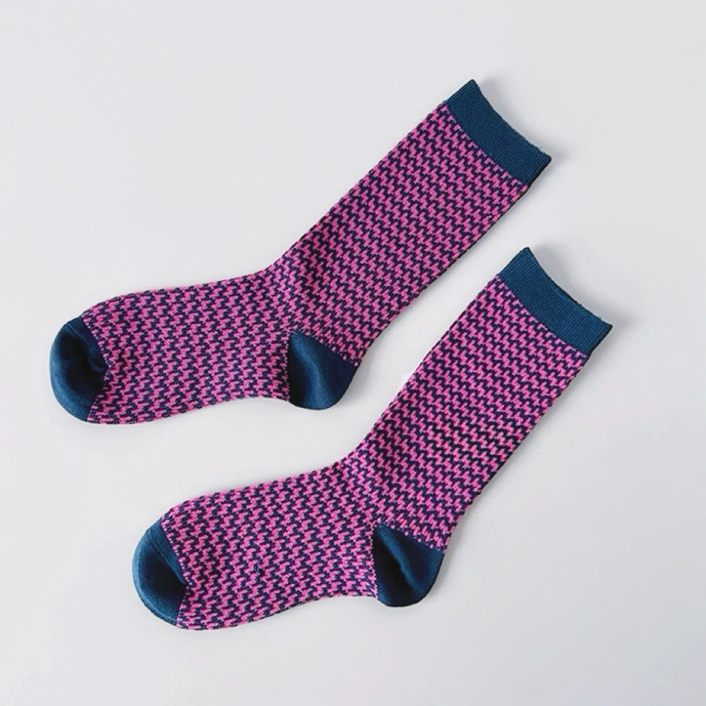 Flat lay of Colored Houndstooth Socks in pink, great for daily wear and lounging.