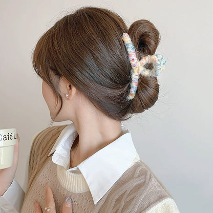 Model wearing  Colored Yarn Hair Claw  in beige, ideal for quick updos and ponytails.