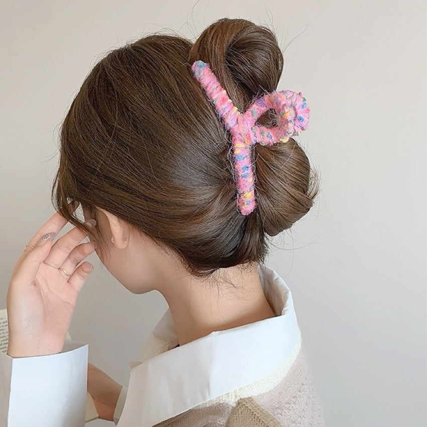 Model wearing  Colored Yarn Hair Claw  in pink, easy for workdays and special occasions.