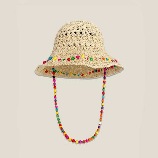 Front view of the beige woven straw hat with a colorful beaded band and hanging cord.