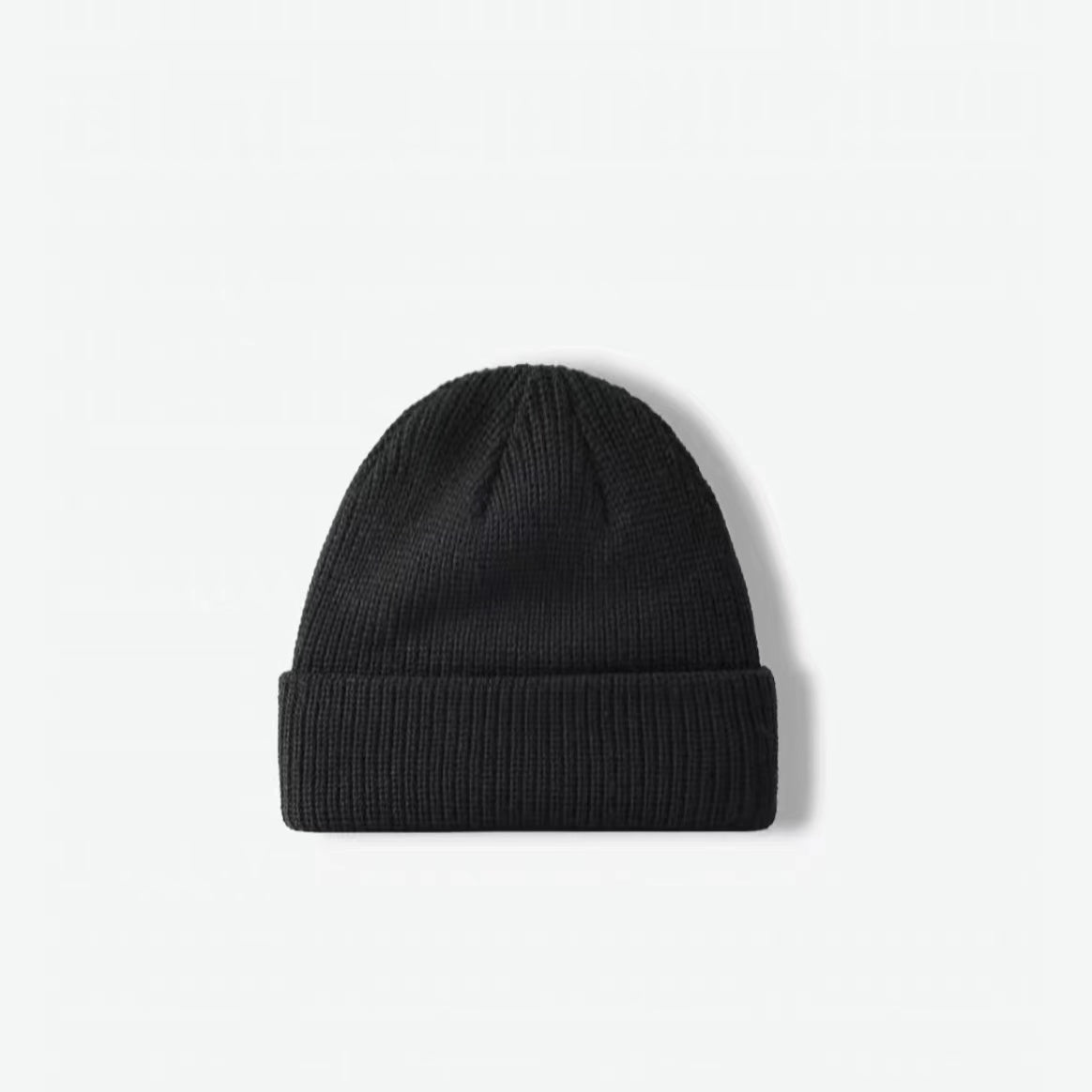 Front view of black multi-color beanie. Subtle dark flecks offer a modern twist on a classic winter staple.