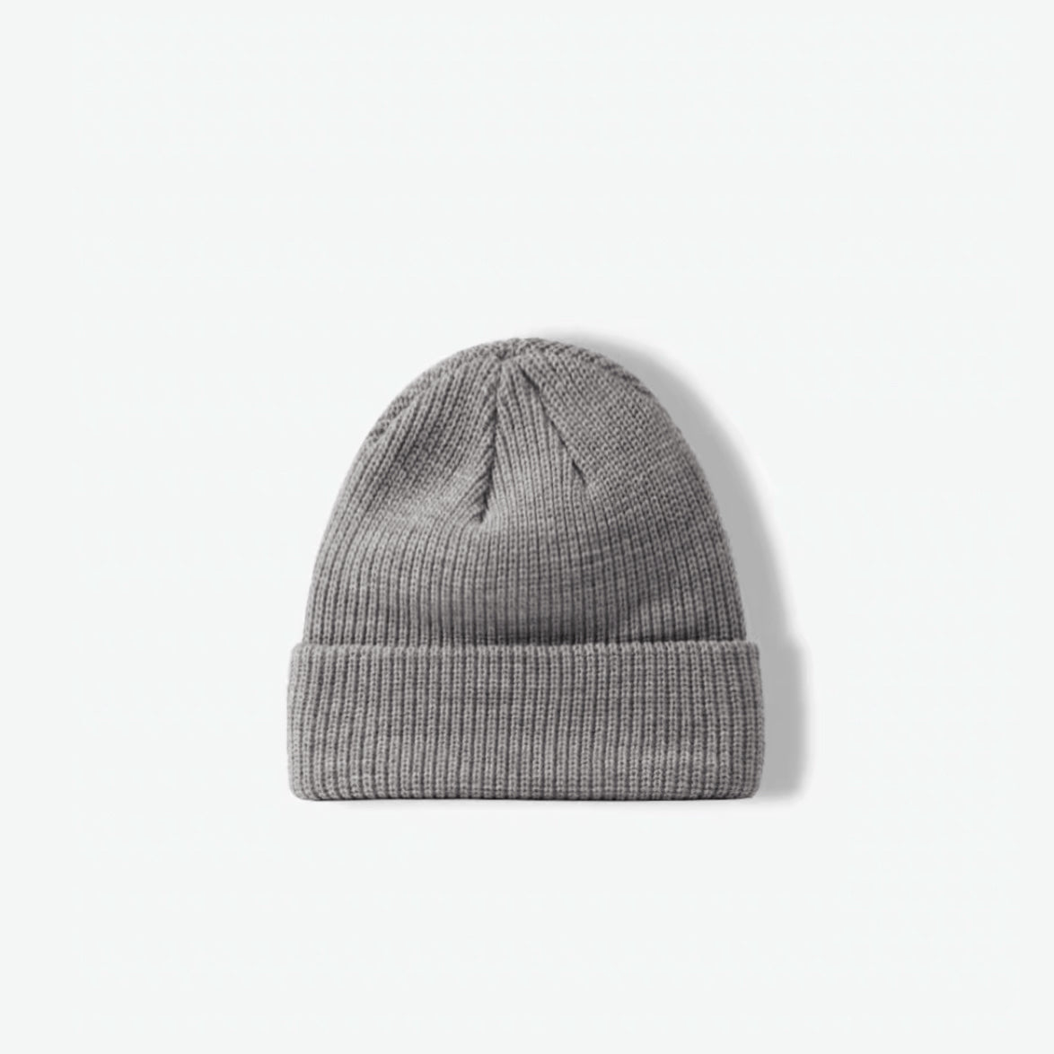 Flatlay view of a classic heather grey ribbed knit beanie on a clean white background.