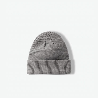 Flatlay view of a classic heather grey ribbed knit beanie on a clean white background.