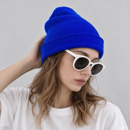 Model wearing a vivid klein blue cuffed beanie hat showing vibrant streetwear styling.