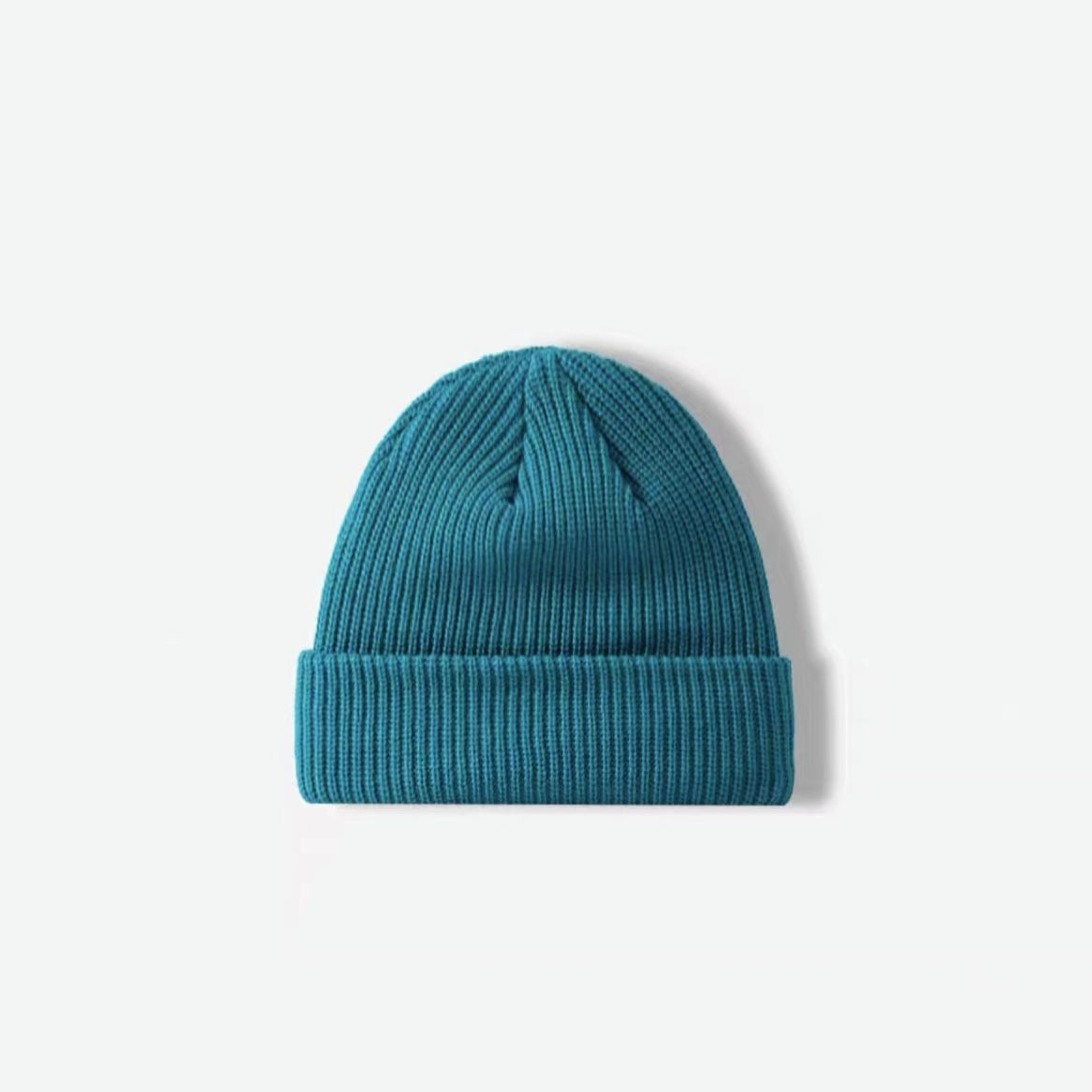 Front view of peacock blue multi-color beanie. Rich oceanic hues for a bold cold-weather fashion statement.