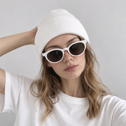Model styling a clean white 100% acrylic ribbed beanie hat paired with casual white t-shirt.