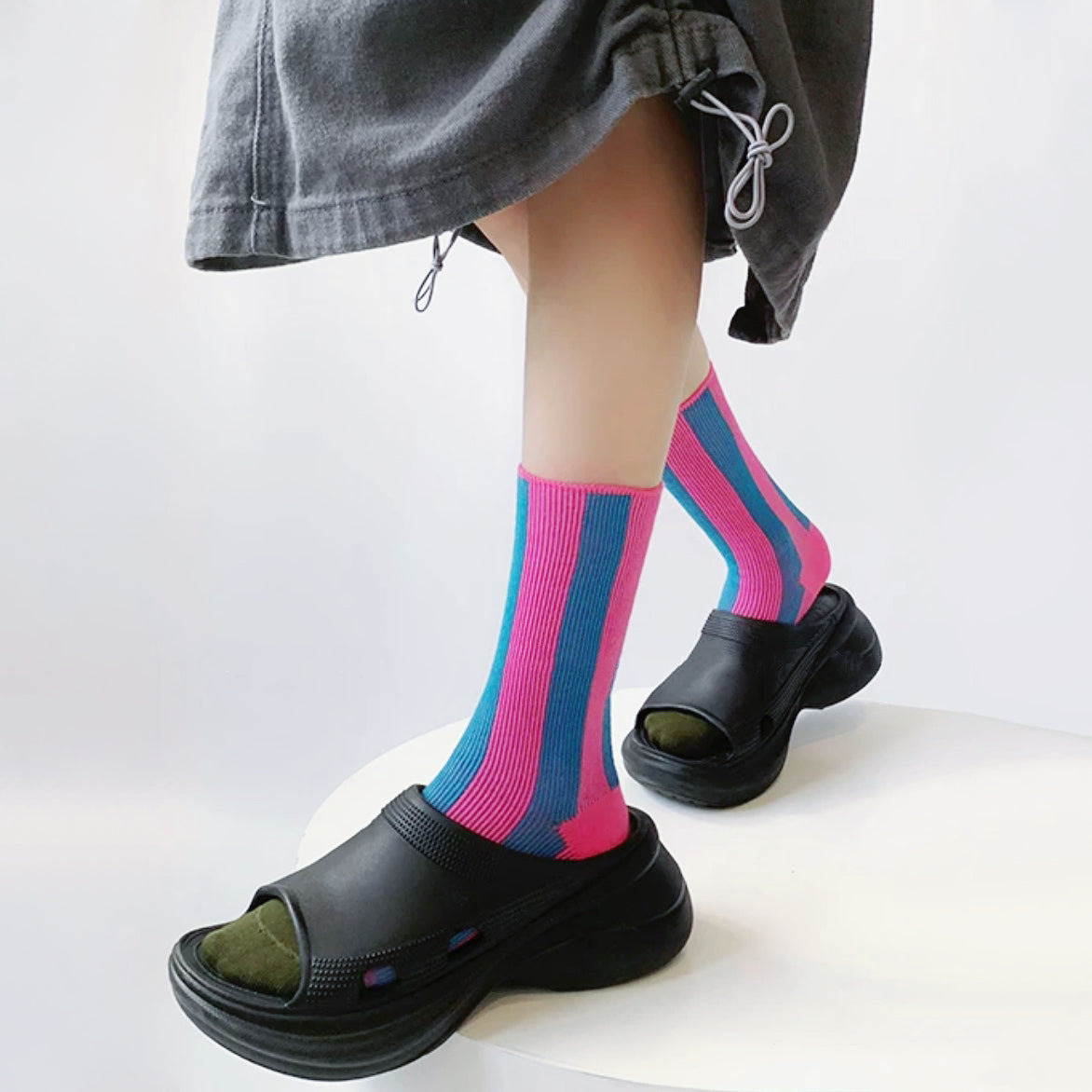 Model wearing a pair of pink Contrast Color Striped Socks, great for casual wear and light workouts.