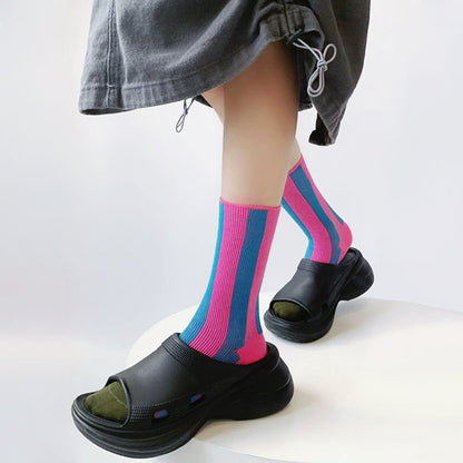 Model wearing a pair of pink Contrast Color Striped Socks, great for casual wear and light workouts.