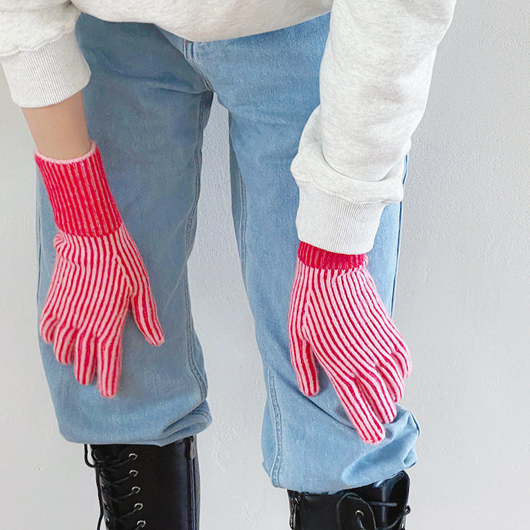 Close-up contrast striped knit gloves with ribbed cuff; cozy warmth for cold-day outfits.