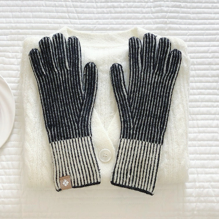 Black contrast striped knit gloves with ribbed cuff and bold banding; classic winter glove style.