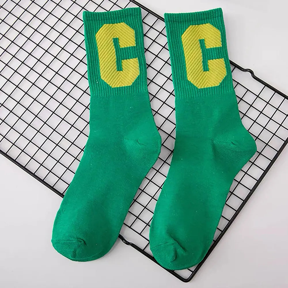 Flat lay of Cool C Socks in green, great for daily wear and lounging.
