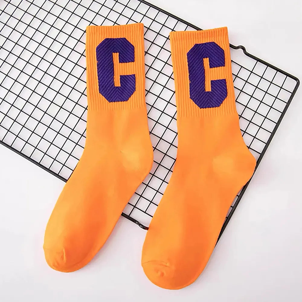 Flat lay of Cool C Socks in orange, easy to pack for travel and errands.