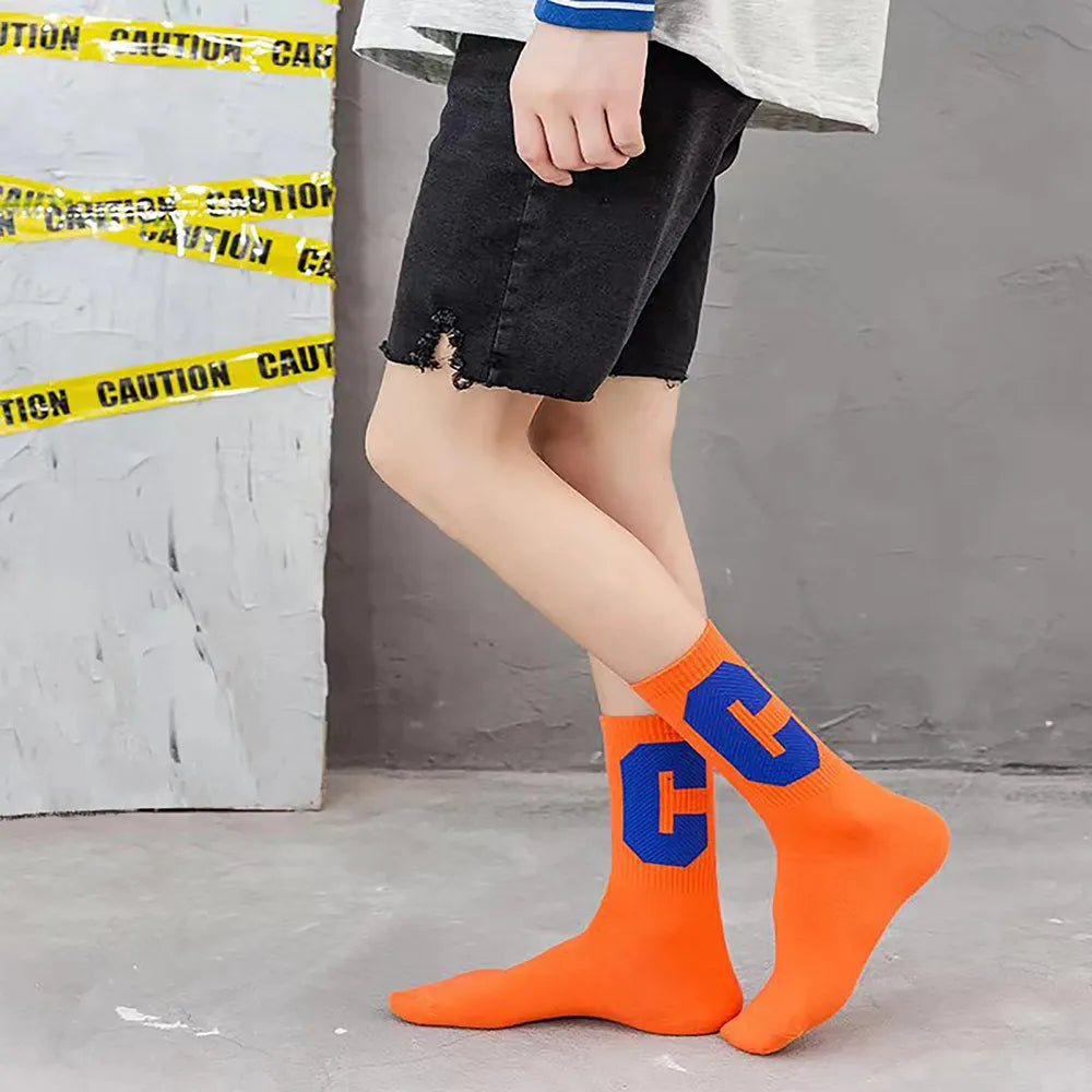 Model wearing a pair of Cool C Socks in orange, great for daily wear and lounging.