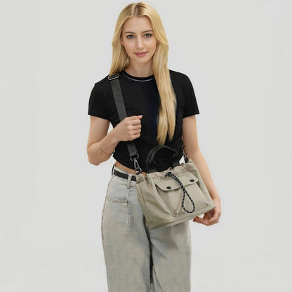 Model wearing the khaki cube bag as a crossbody.
