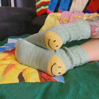 Styling green smiley knitted socks for a cozy home aesthetic, featuring a trendy and happy street-style vibe.