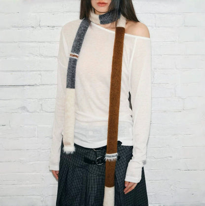 Model wearing a wool scarf in beige and brown, great for office layering and commuting.