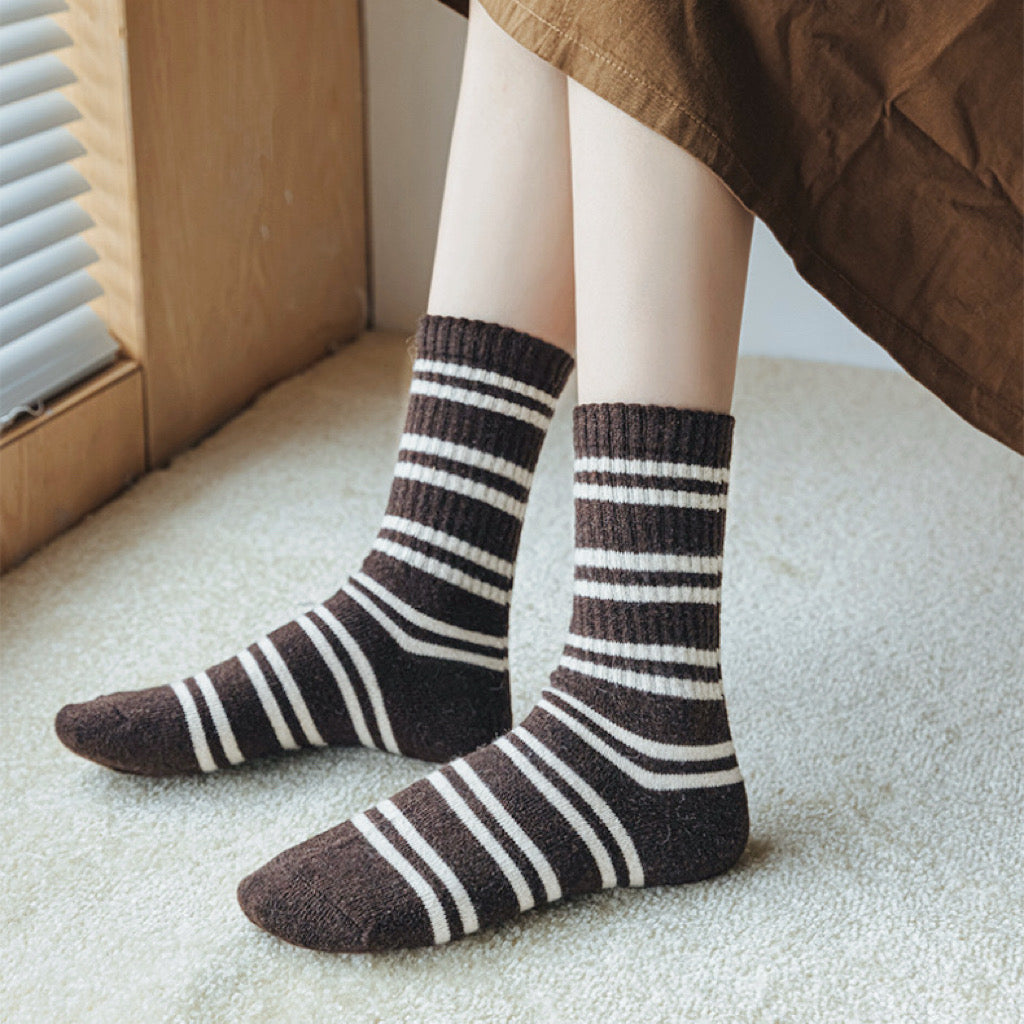 Model wearing a pair of brown striped wool socks, easy for travel days and daily comfort.