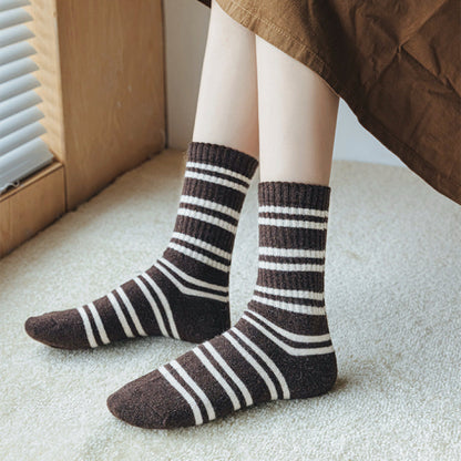 Model wearing a pair of brown striped wool socks, easy for travel days and daily comfort.
