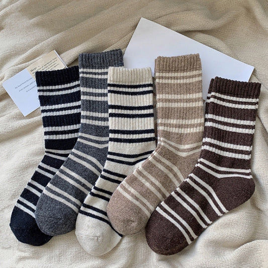 Front view of Five pairs of cozy wool striped crew socks in black, gray, cream, beige, and brown in beige socks.