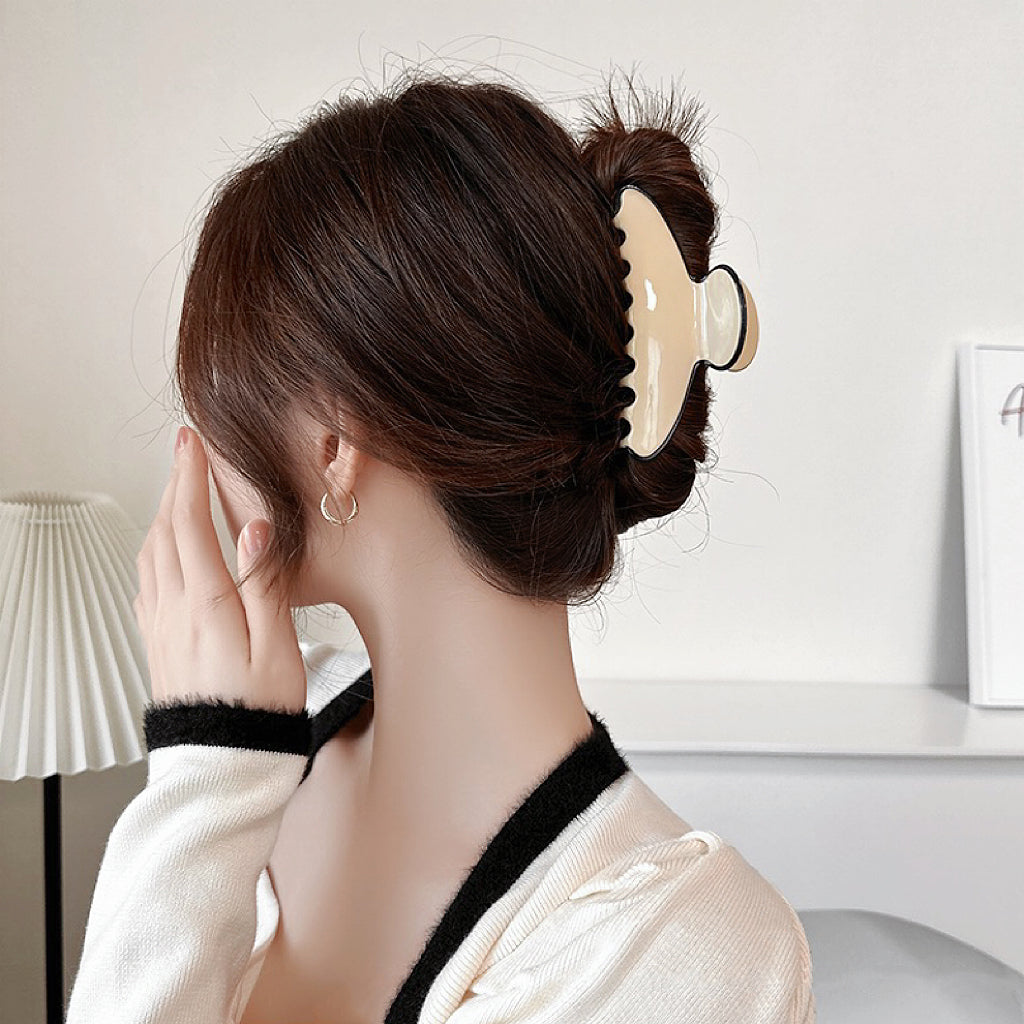Model wearing Cream Black Border Hair Claw in curve shape, easy for workdays and special occasions.