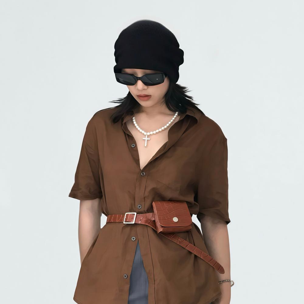Model wearing the tan crocodile leather belt with pouch, featuring a casual chic.