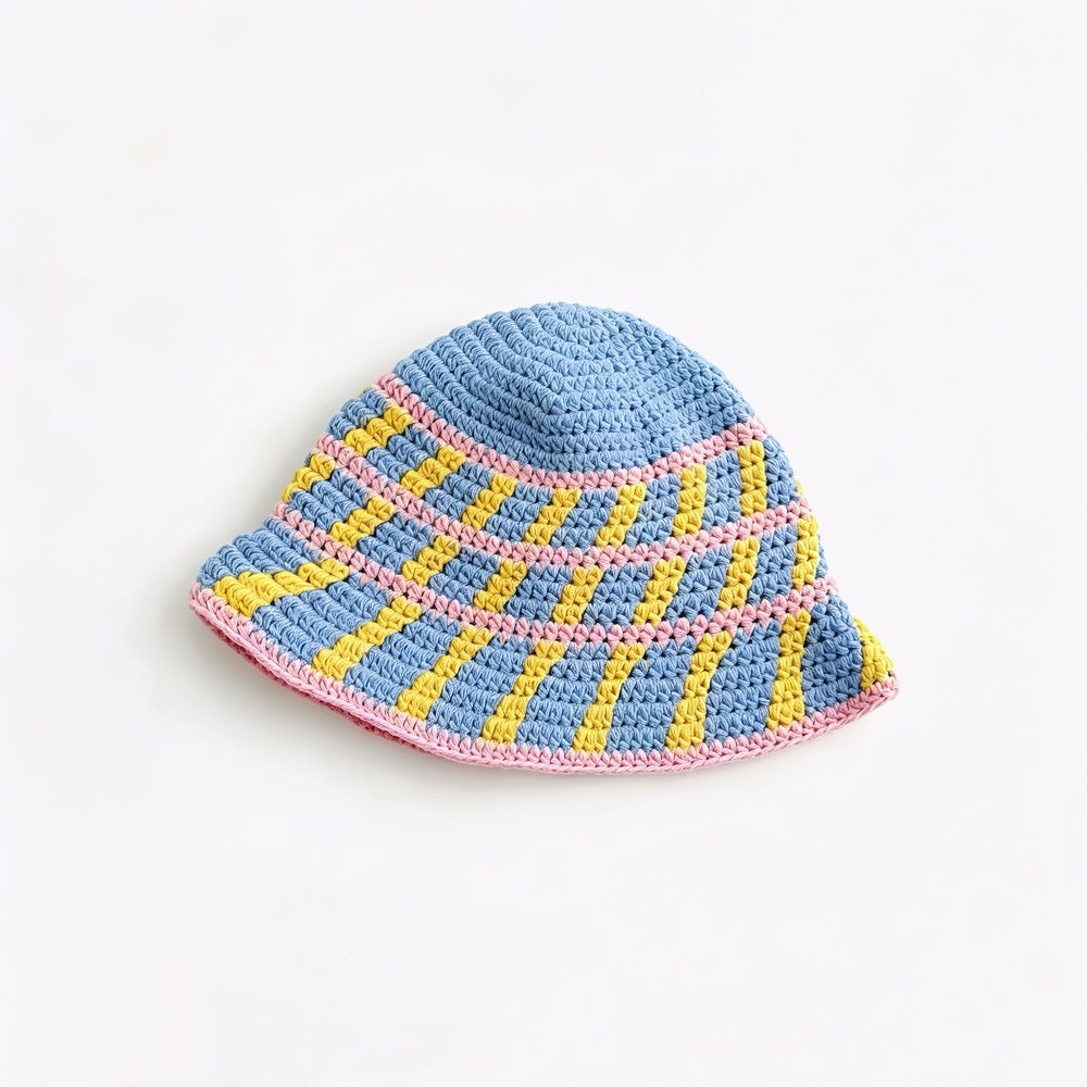 Detailed top view of the blue bucket hat, with pink and yellow cross striped pattern.