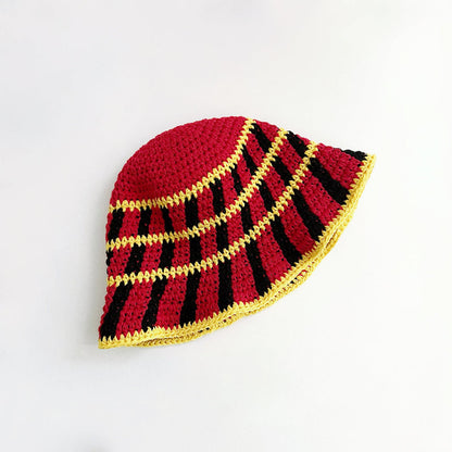 Detailed top view of the red bucket hat, with yellow and black cross striped pattern.