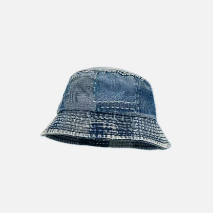 Multi-wash blue denim patchwork bucket hat featuring visible stitching and an artisanal retro look.