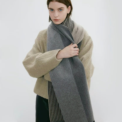 Model wearing a striped scarf in gray and beige, easy for weekend styling and gifting.