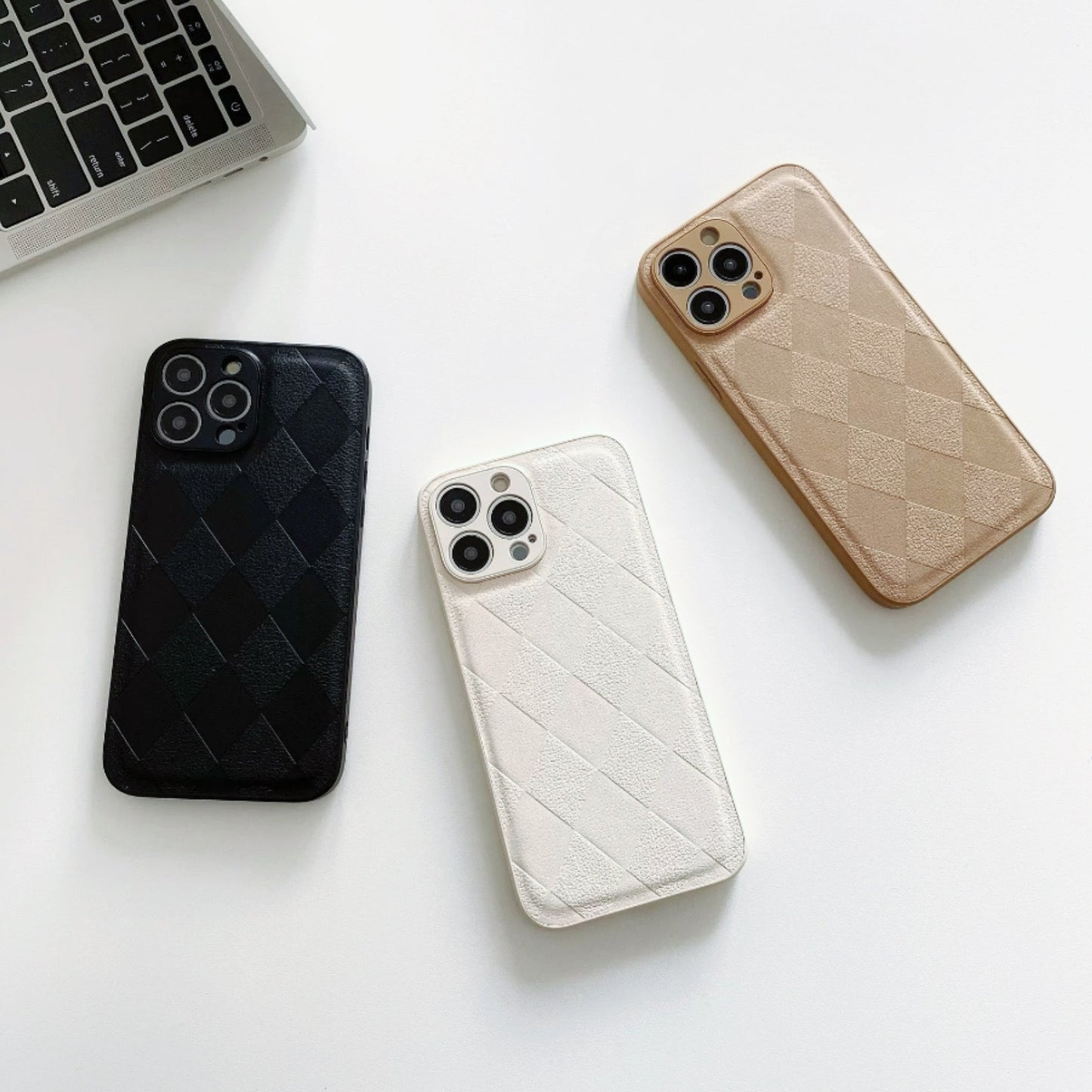 Collection of diamond pattern PU leather cases in black, white, and gold. Elegant sophisticated accessories.