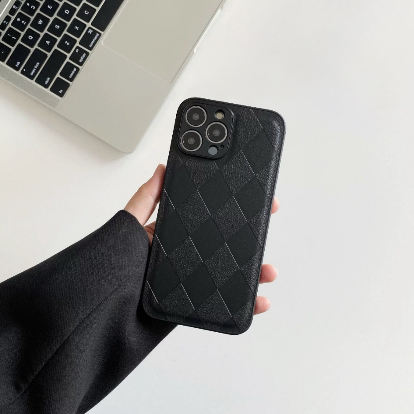 Model holding black Diamond Pattern Leather Case. Elegant embossed diamond-quilt for Old Money style.