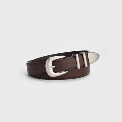 Close-up view of the brown leather belt showing the vintage silver pointed buckle and double keeper loops.