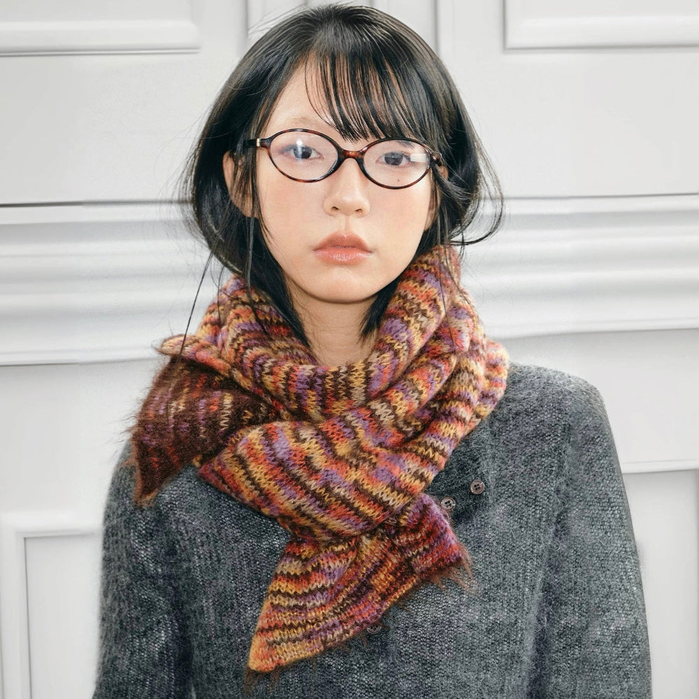 Model wearing Dual-Sided Aurora Texture Soft Scarf, a wool blend scarf with multicolored stripes in brown.