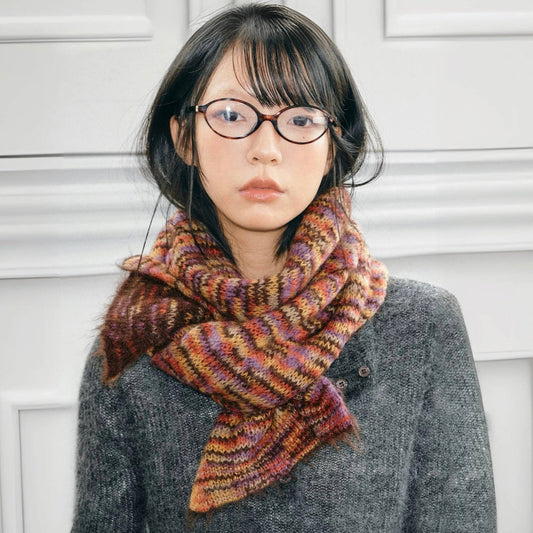 Model wearing Dual-Sided Aurora Texture Soft Scarf, a wool blend scarf with multicolored stripes in brown.