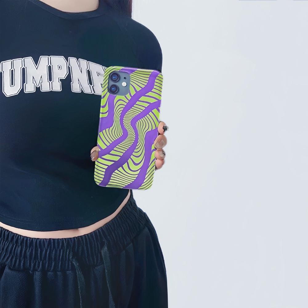 Model holding Electronic Vortex Case. Showcasing futuristic neon pattern for edgy modern street fashion.