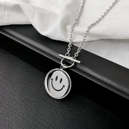 Flat lay of silver titanium steel emoti spin necklace on a dark surface