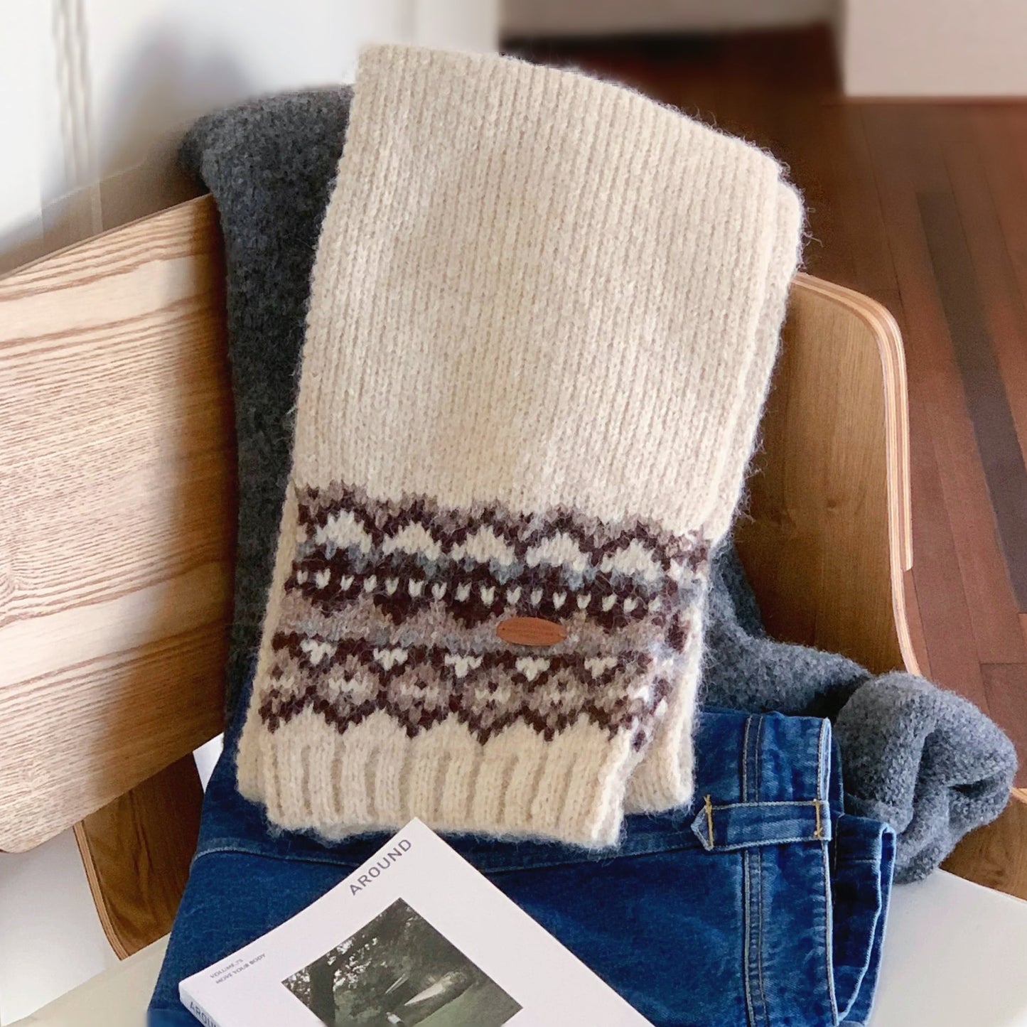 Model wearing a wool scarf in beige, easy for weekend styling and gifting.