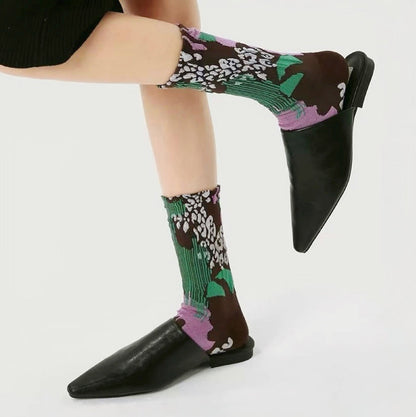 Model wearing a pair of Fantasy Garden Socks, easy to pack for travel and errands.