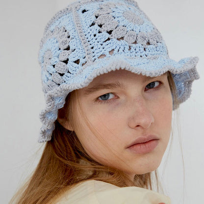 Model wearing blue Floral Crochet Hat. Bright cheerful patterns in a premium polyester-cotton blend.