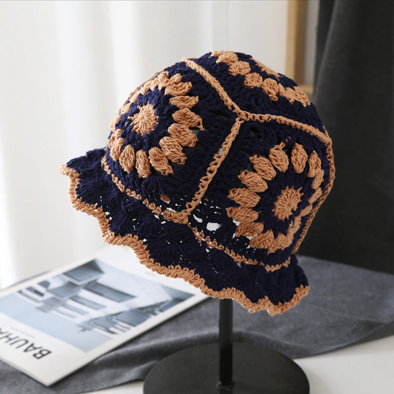 Navy blue and tan floral crochet bucket hat made of breathable polyester-cotton for all-day comfort.
