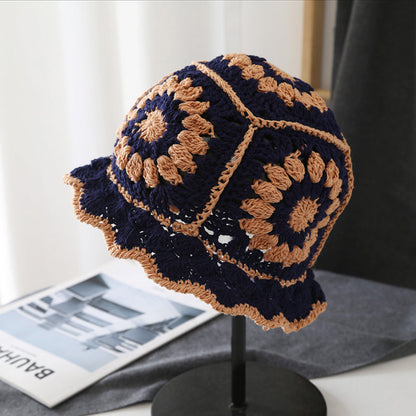 Navy blue and tan floral crochet bucket hat made of breathable polyester-cotton for all-day comfort.