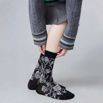 Model wearing a pair of black Floral Embroidered Socks, great for casual wear and light workouts.