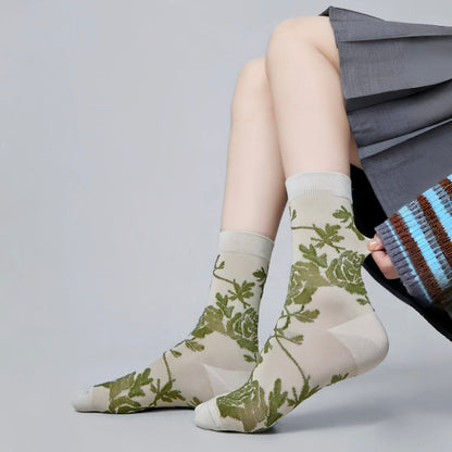 Model wearing a pair of celadon Floral Embroidered Socks, easy to pack for travel and errands.