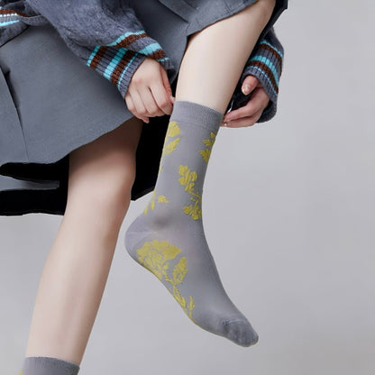Model wearing a pair of  Floral Embroidered Socks in gray, great for daily wear and lounging.