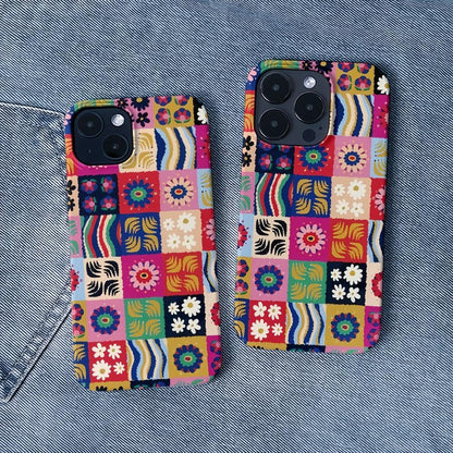 Floral patchwork silicone case shown on a denim background. Vintage-inspired aesthetic lifestyle shot.