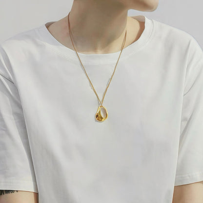 Model styling a Fluid Shapede Pendant Necklace in Gold, ideal for date nights.