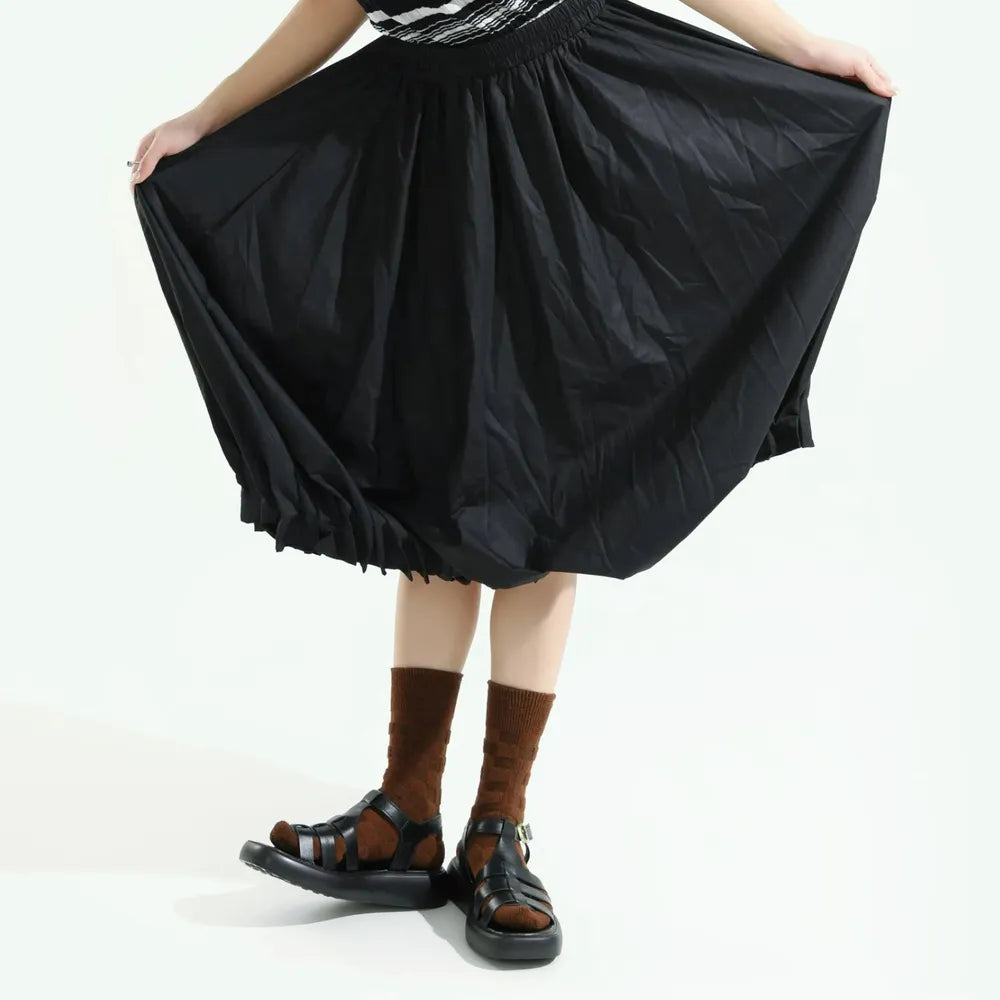 Model wearing a pair of Fuzzy Check Textured Socks in brown, easy to pack for travel and errands.