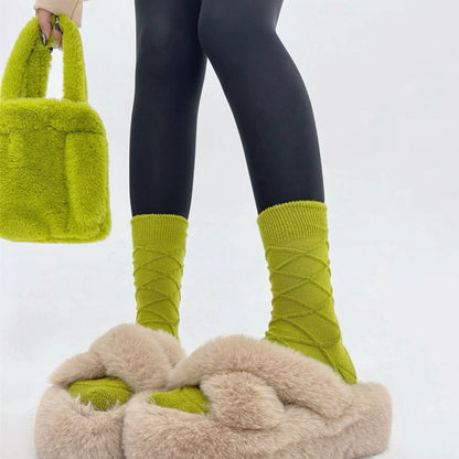 Model wearing a pair of green Fuzzy Embossed Socks, great for casual wear and light workouts.
