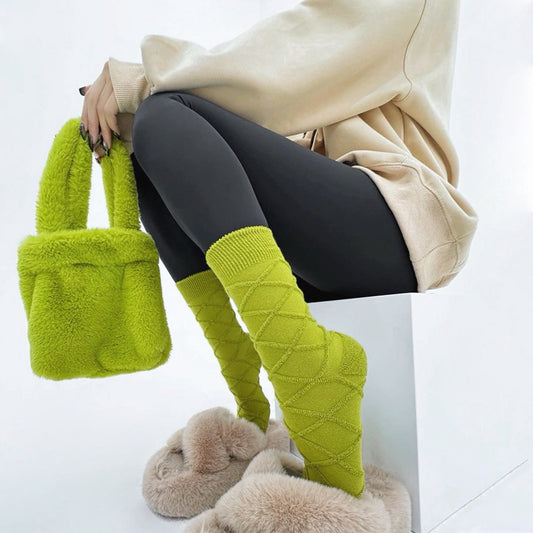 Model wearing Fuzzy embossed  socks in vibrant lime green with a diamond pattern, paired with a matching fluffy.