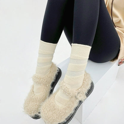 Model wearing a pair of  Fuzzy Embossed Socks in white, ideal for workouts and commuting.